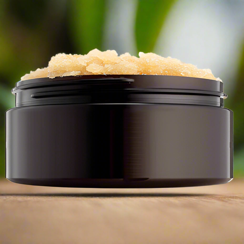 Artisan Farm Stand 9oz Body Scrub in a jar with a natural wood lid, featuring a label showcasing its organic ingredients and soothing scent, placed on a rustic wooden surface.