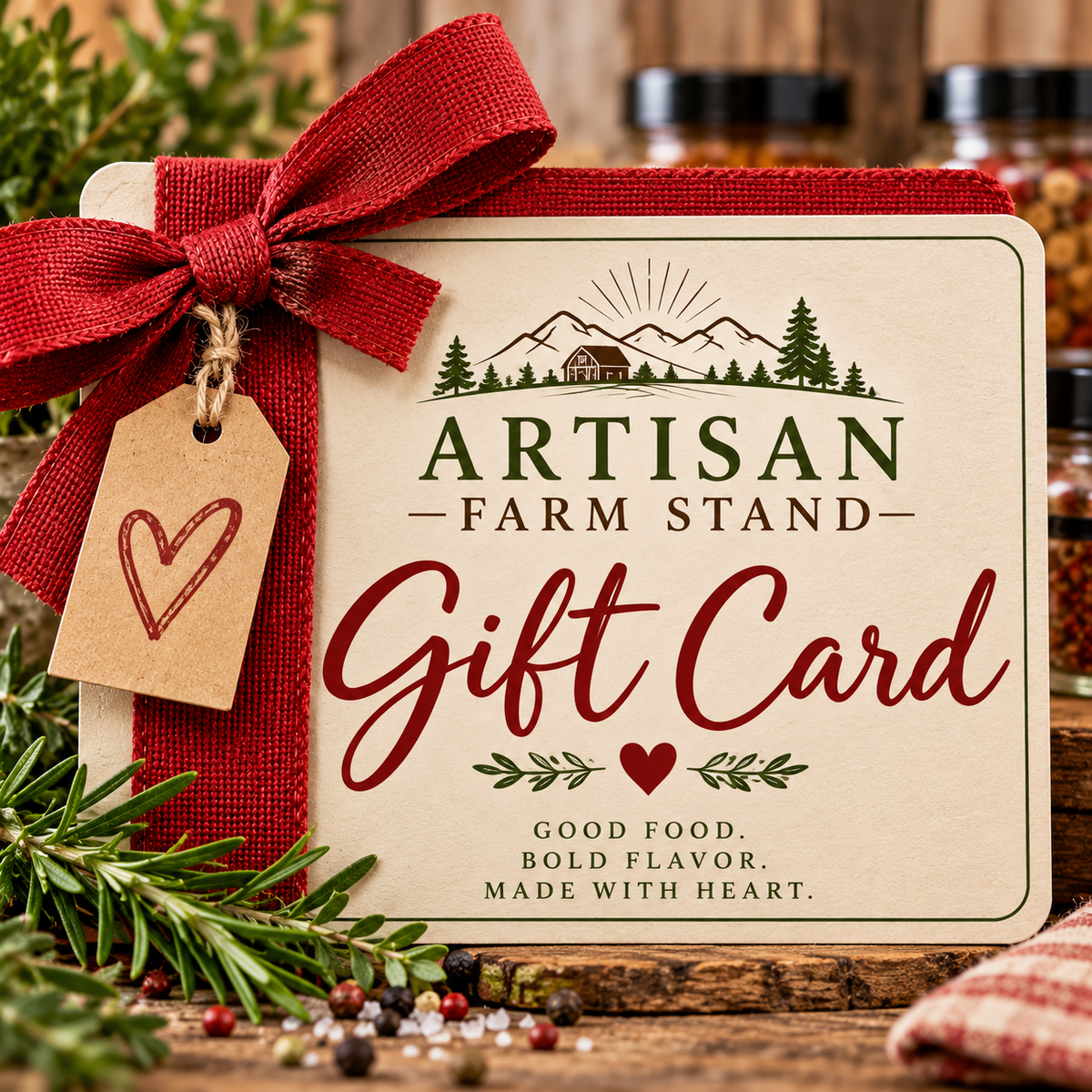 An artisan farm stand gift card tied with a red burlap ribbon and hanging kraft tag, styled with pine branches and spices on a rustic wooden surface. The card reads 'ARTISAN FARM STAND Gift Card' and 'GOOD FOOD.