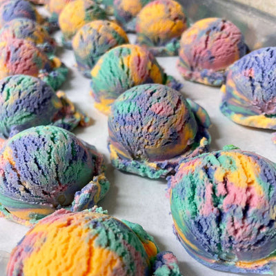 Colorful Bubble Scoops Bubble Bath arranged on a tray, providing a luxurious spa experience with skin-nourishing ingredients and rich, fragrant bubbles.