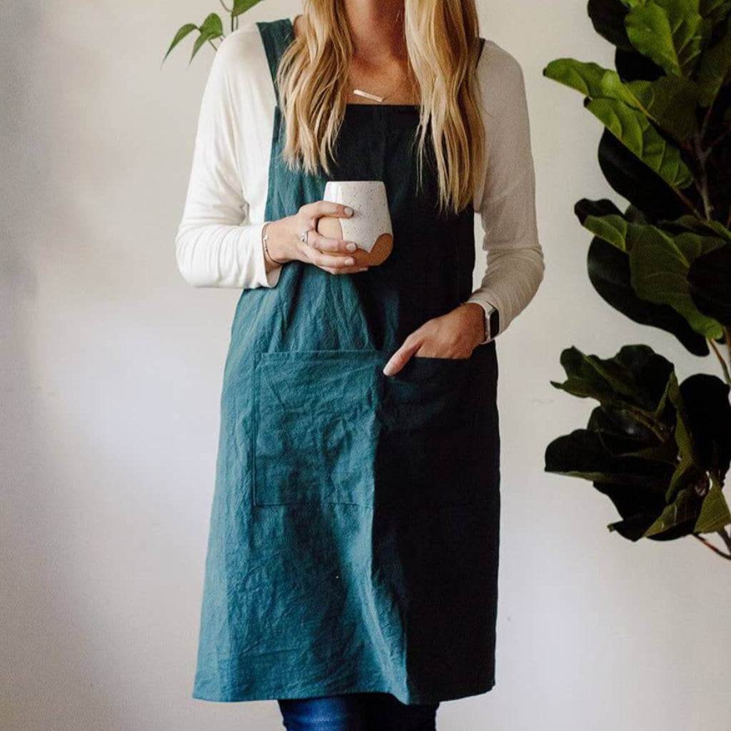 Handmade cross-back apron with deep pockets, durable fabric, and a comfortable fit for kitchen, gardening, or crafting