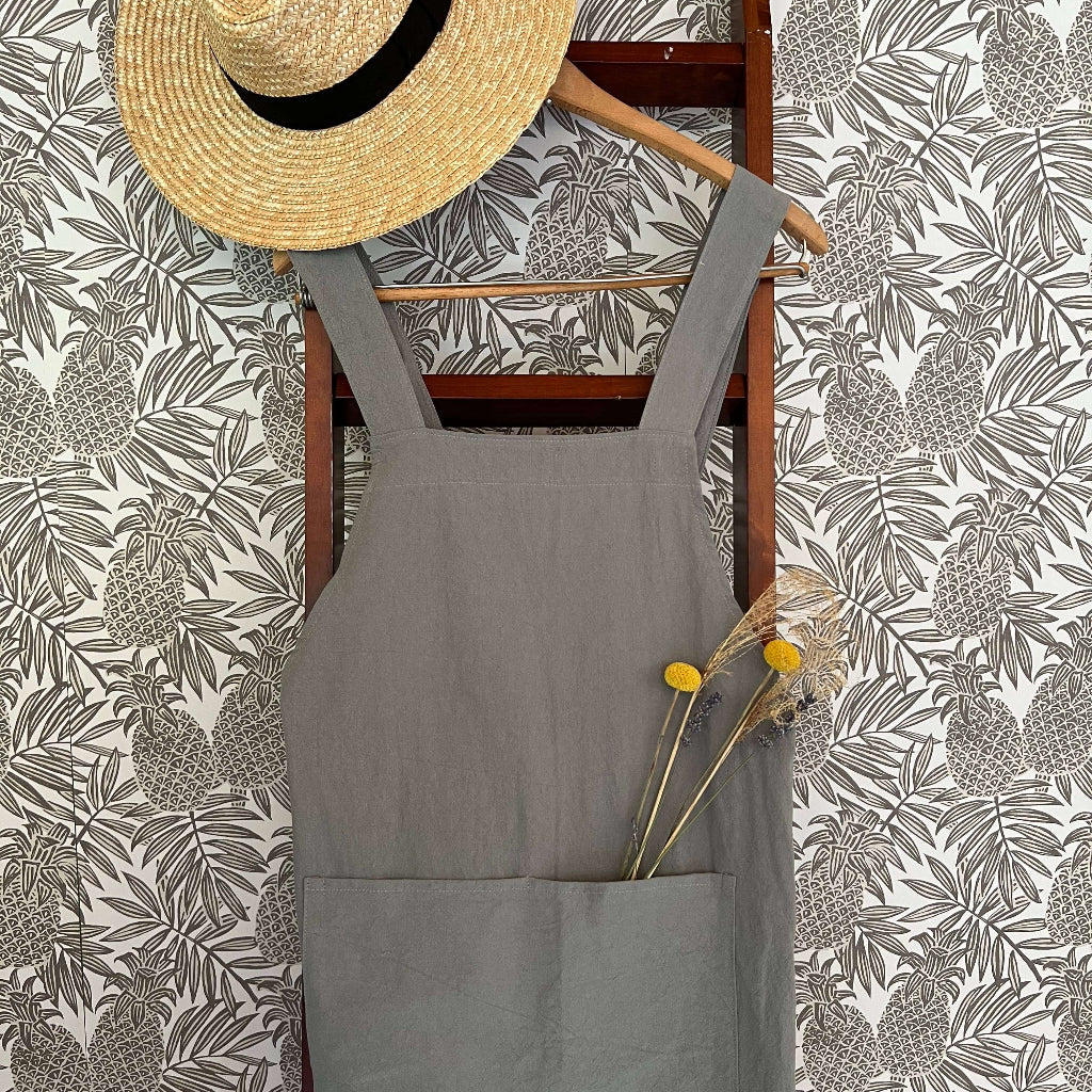 Handmade cross-back apron with deep pockets, durable fabric, and a comfortable fit for kitchen, gardening, or crafting