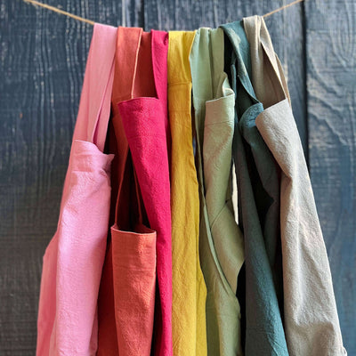 Handmade cross-back apron with deep pockets, durable fabric, and a comfortable fit for kitchen, gardening, or crafting