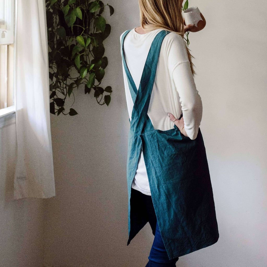 Handmade cross-back apron with deep pockets, durable fabric, and a comfortable fit for kitchen, gardening, or crafting